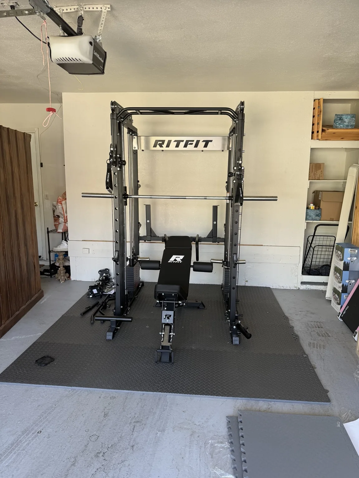 Strength training rack and bench assembled in a garage